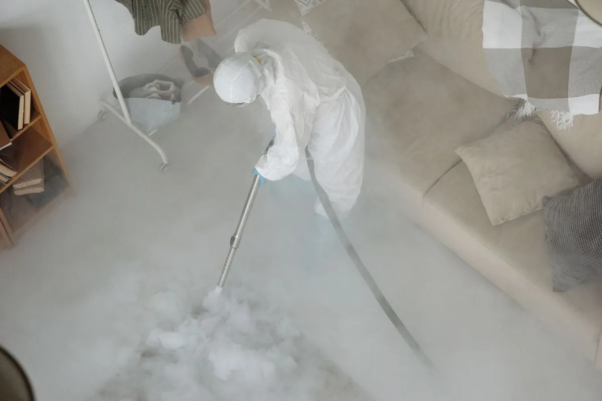 Biohazard cleanup technician in protective equipment, Farmington, AR